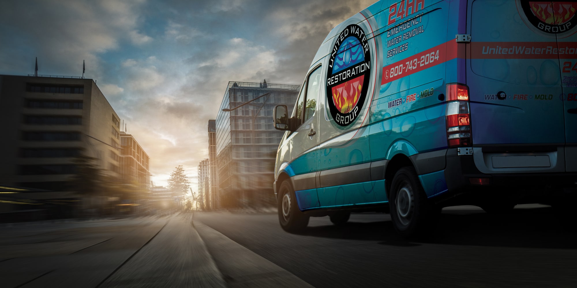 A United Water Restoration Group of Mobile van heading out on an emergency call at sunset